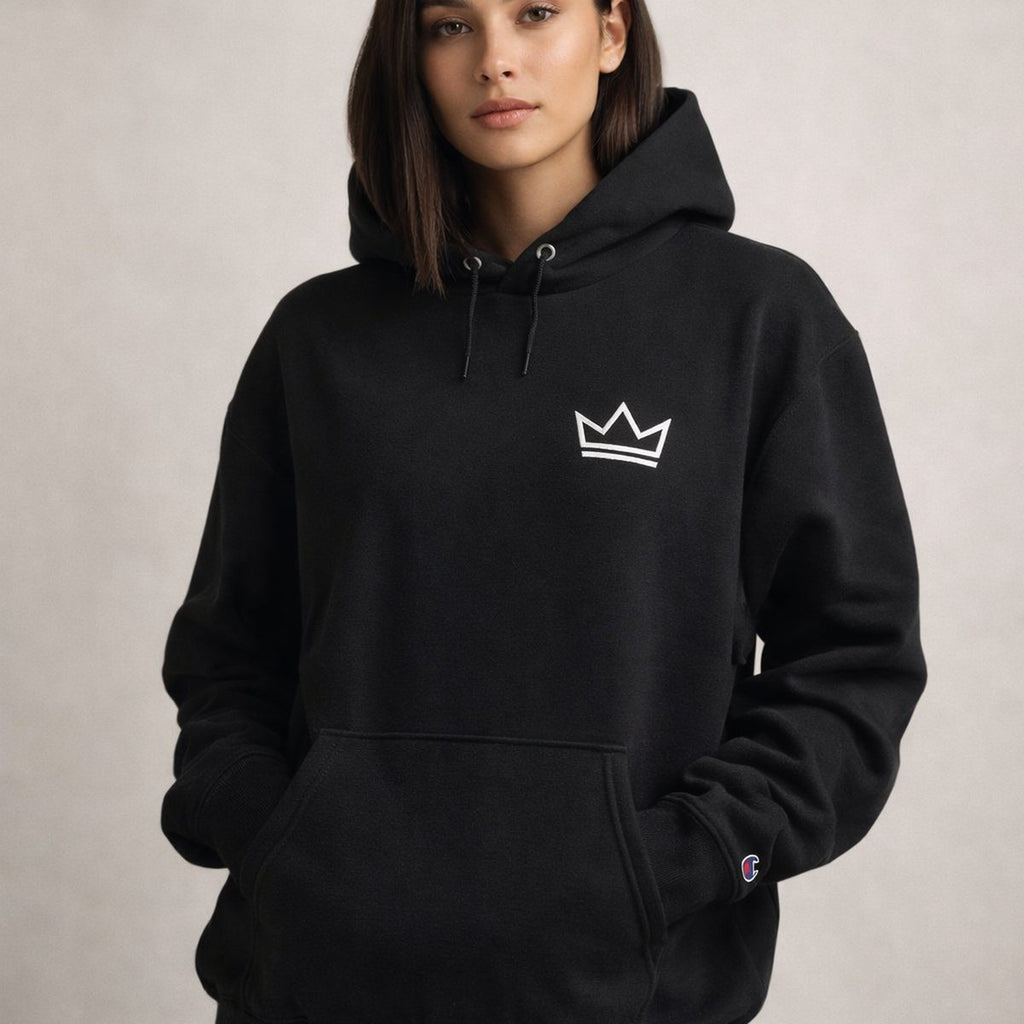 Female model wearing women's black PurposeDriven crown hoodie with embroidered logo