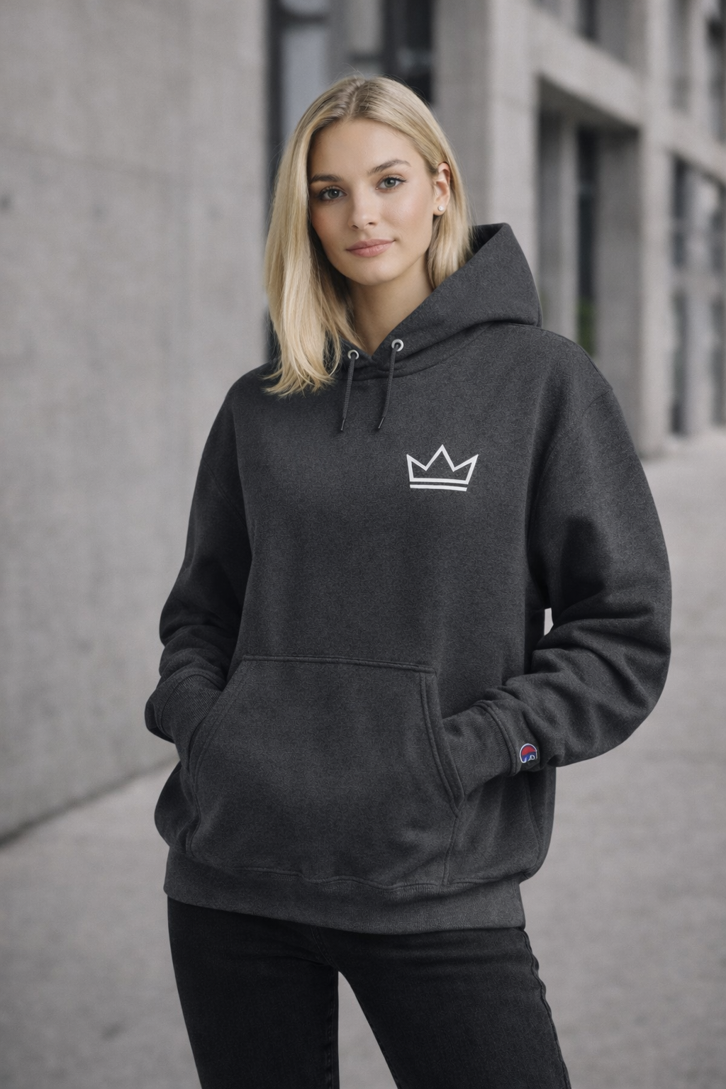 Female model wearing women's charcoal PurposeDriven crown hoodie with embroidered logo