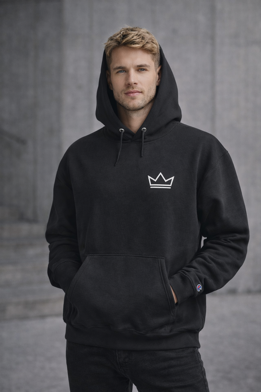 Male model wearing men's black PurposeDriven crown hoodie with embroidered logo