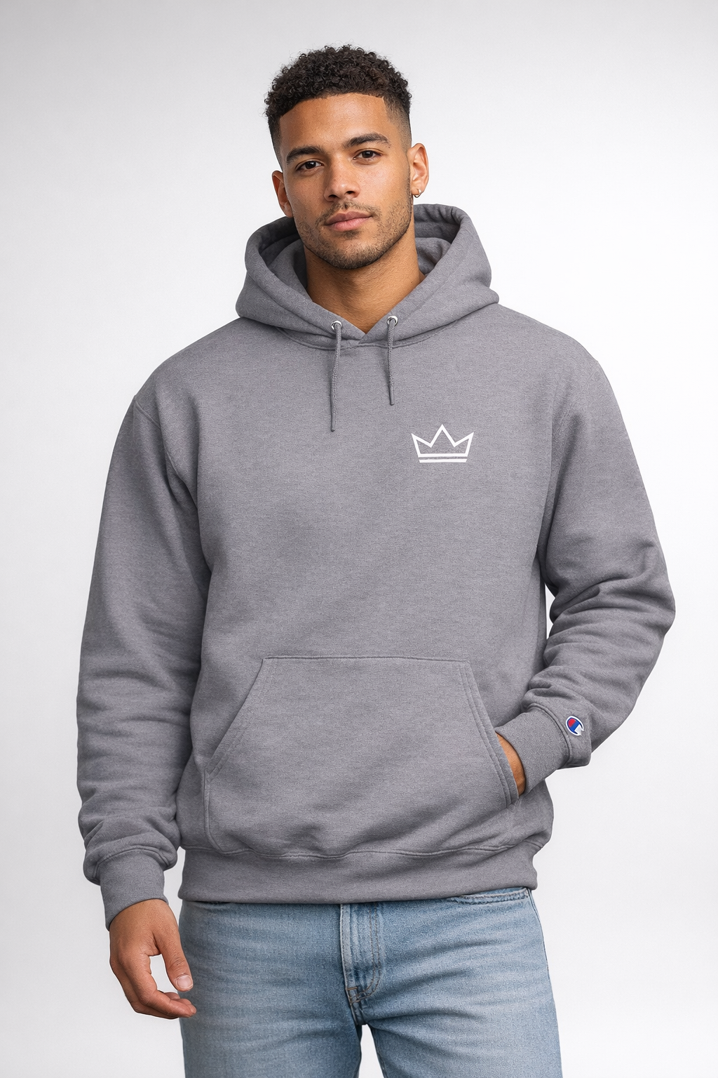 Male model wearing men's grey PurposeDriven crown hoodie with embroidered logo
