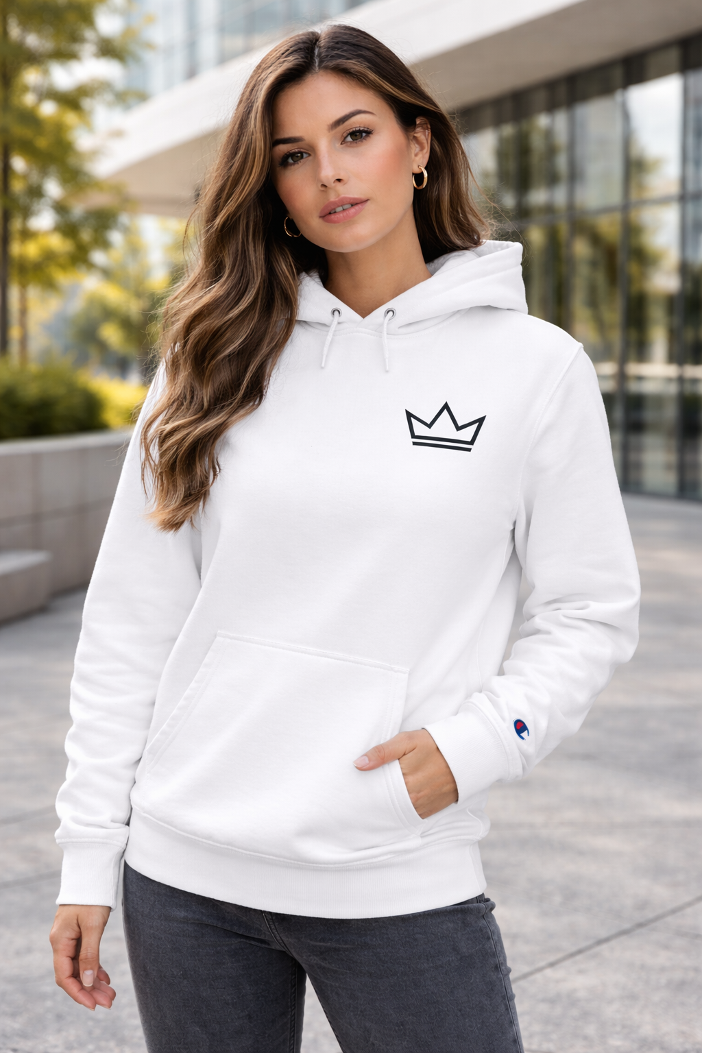 Women’s white Ascension hoodie by PurposeDriven, Champion® pullover with minimalist crown logo worn in urban setting