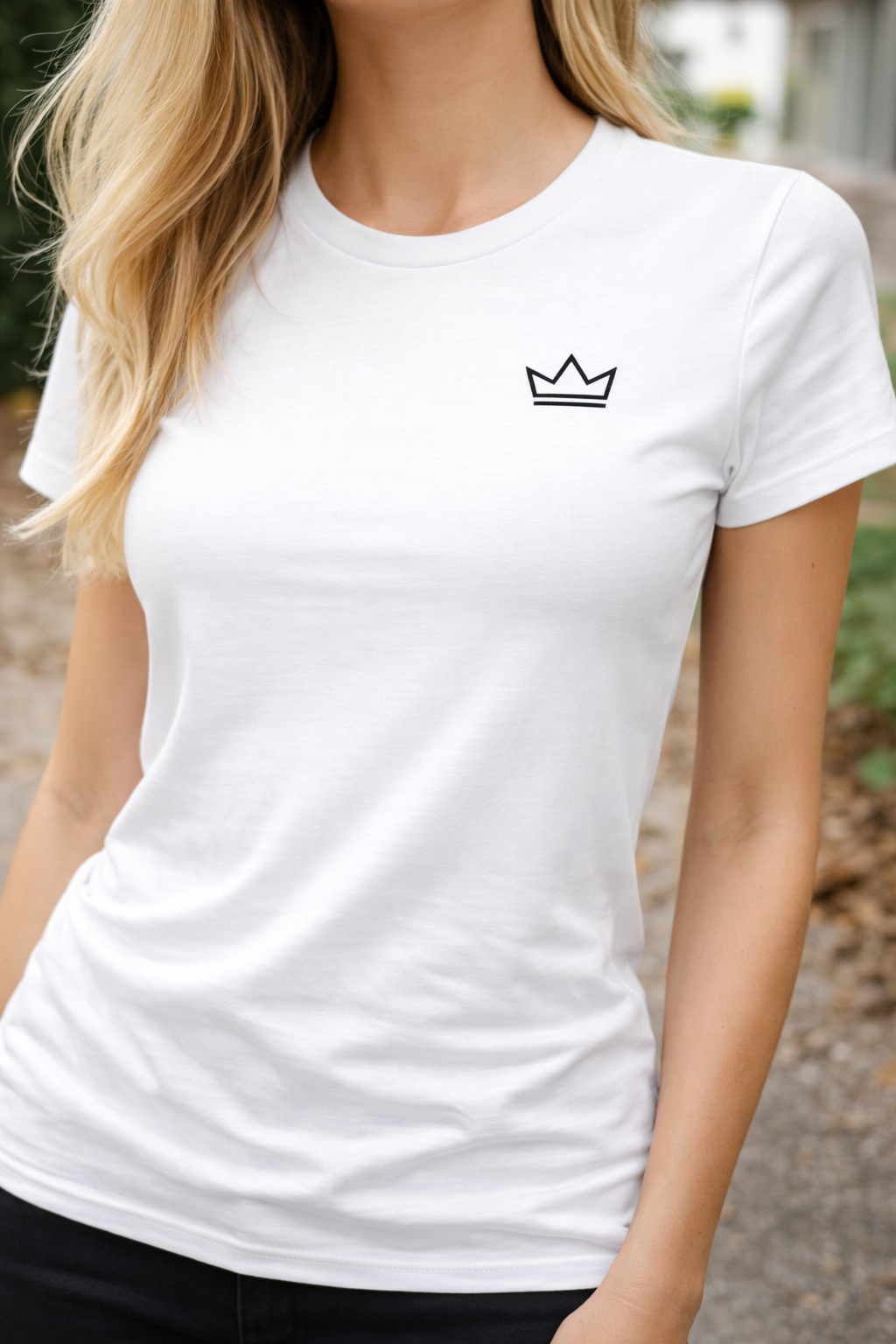 Woman wearing a white classic-fit t-shirt with small black crown logo, minimalist streetwear tee by PurposeDriven