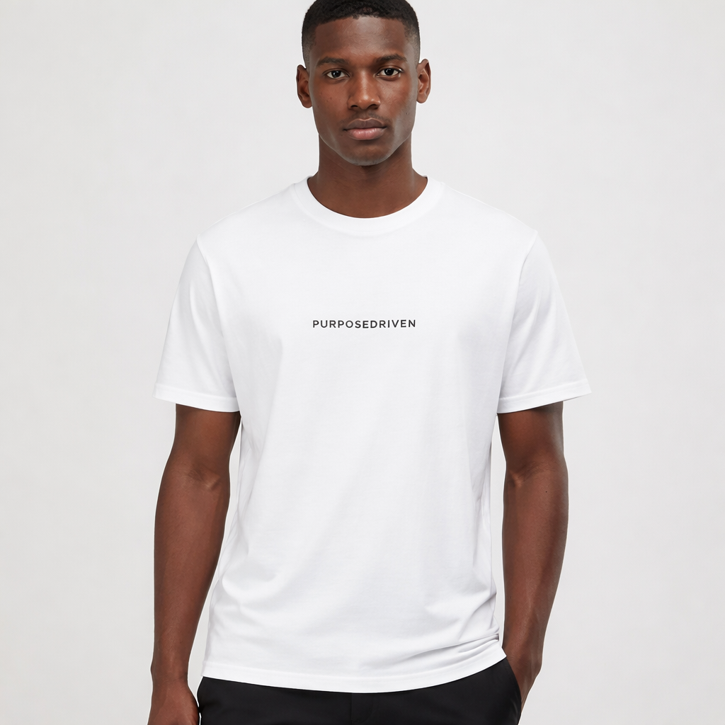 Male model wearing white PurposeDriven minimalist t-shirt, premium motivational streetwear on neutral studio background