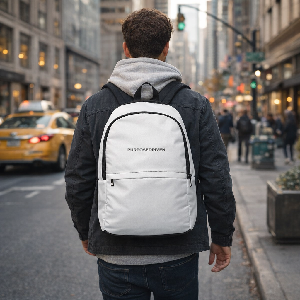 PurposeDriven™ minimalist white backpack worn by model in urban city street setting for everyday carry
