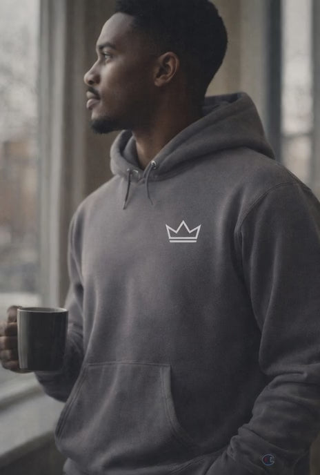 Male model wearing PurposeDriven Champion Crown Hoodie in charcoal grey, minimalist pullover with crown logo, lifestyle product video.